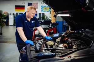 Mechanic Looking into Engine Area